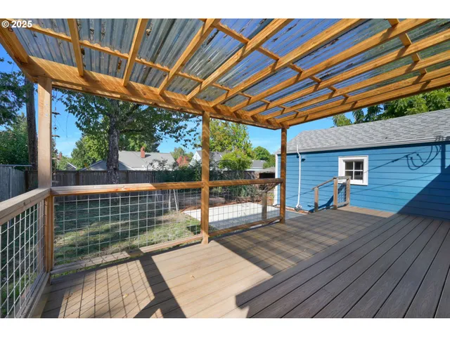 a view of backyard with a deck and wooden floor