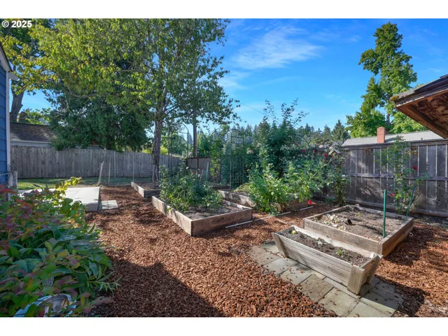 a backyard of a house with fountain table and chairs