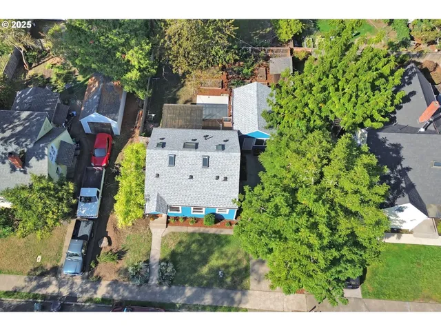 aerial view of a house with a yard and garden