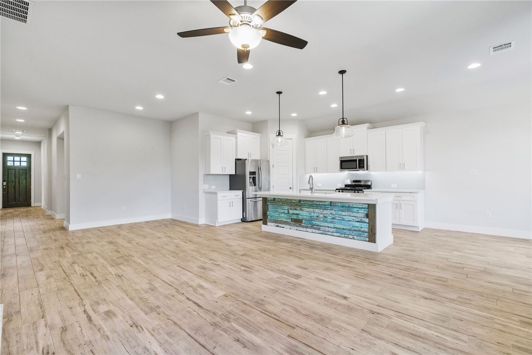 941 Del Raphael Drive Leander, TX 78641 - Photo 7 of 33 This layout is built for real life; you can easily chat with someone at the kitchen island without leaving the couch