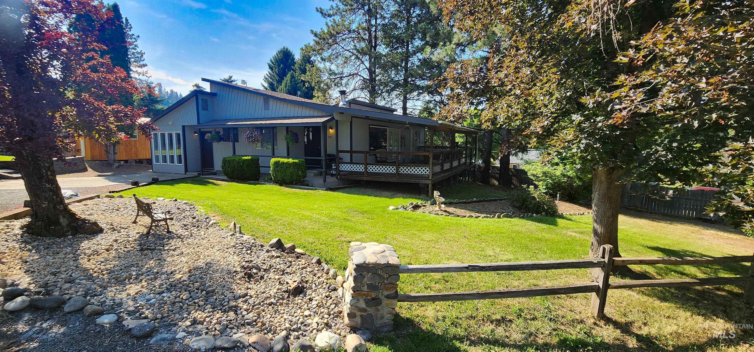 View of front of house featuring a wooden deck