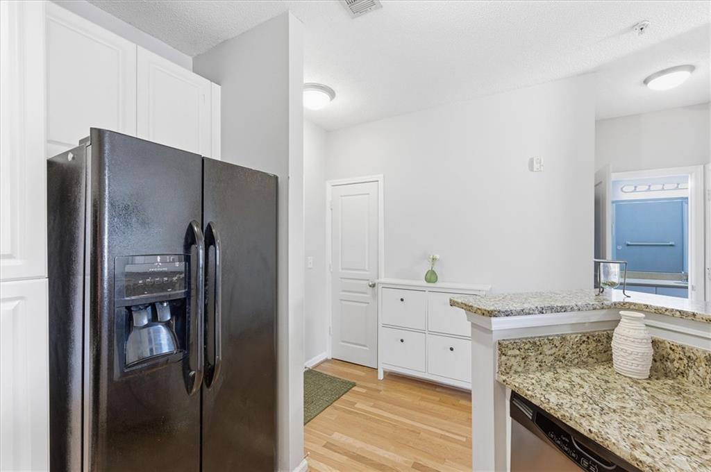 10 Perimeter Summit Boulevard, Unit 2410 Atlanta, GA 30319 - Photo 15 of 31 a kitchen with stainless steel appliances granite countertop a refrigerator and a sink