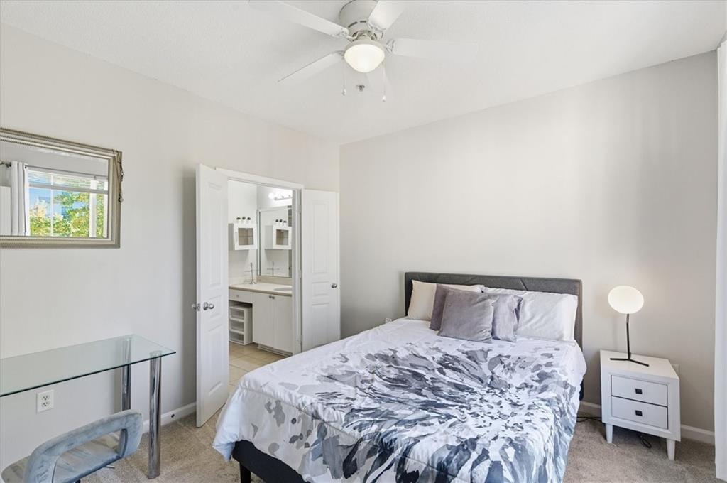 10 Perimeter Summit Boulevard, Unit 2410 Atlanta, GA 30319 - Photo 16 of 31 a bedroom with a bed and a window