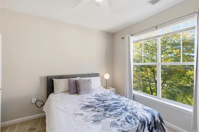 a bedroom with a bed and a window