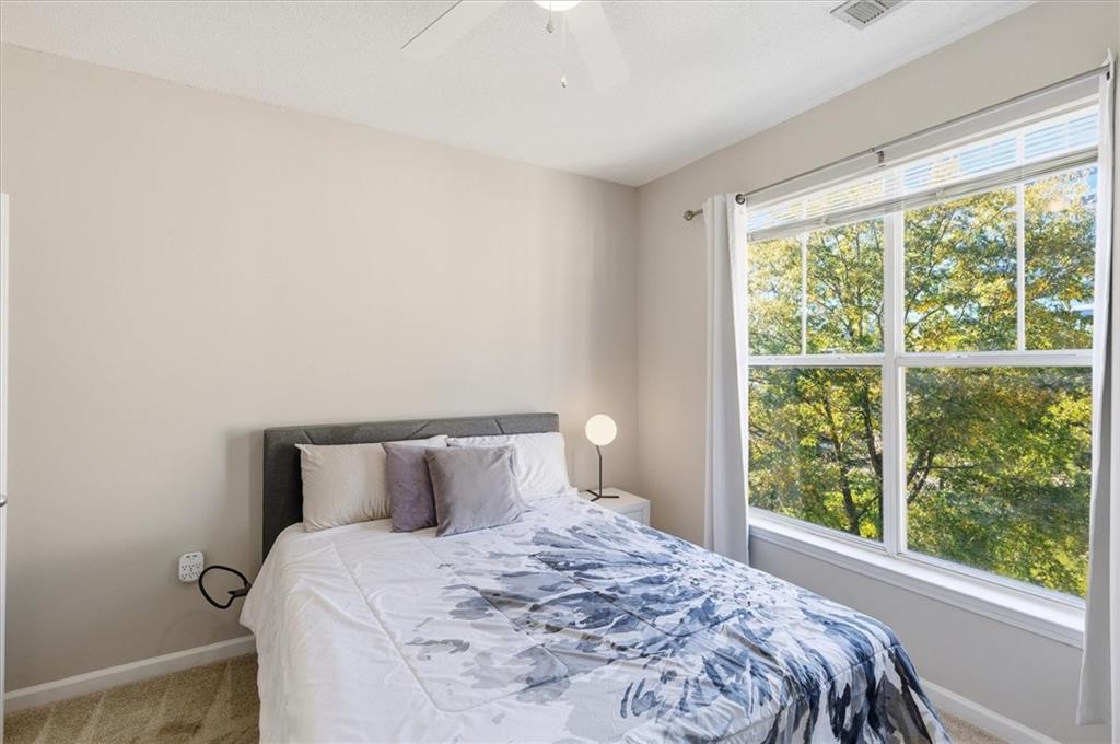 10 Perimeter Summit Boulevard, Unit 2410 Atlanta, GA 30319 - Photo 18 of 31 a bedroom with a bed and window