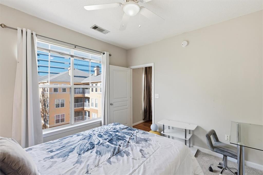 10 Perimeter Summit Boulevard, Unit 2410 Atlanta, GA 30319 - Photo 19 of 31 a bedroom with a bed and a window