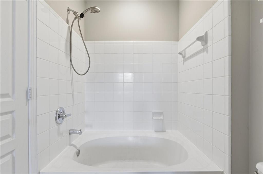 10 Perimeter Summit Boulevard, Unit 2410 Atlanta, GA 30319 - Photo 22 of 31 a bathroom with a bath tub with a shower