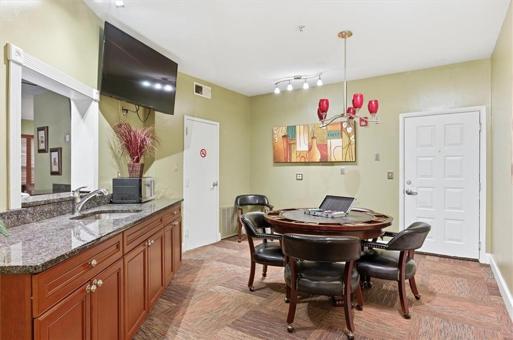 10 Perimeter Summit Boulevard, Unit 2410 Atlanta, GA 30319 - Photo 31 of 31 a kitchen with a table and chairs in it