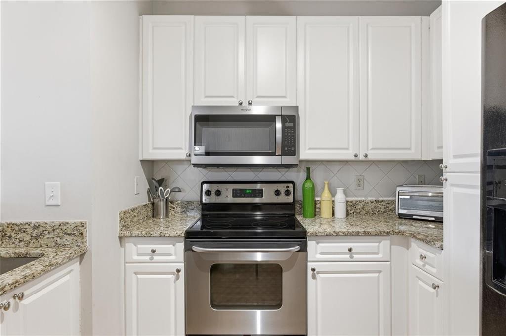10 Perimeter Summit Boulevard, Unit 2410 Atlanta, GA 30319 - Photo 10 of 31 a kitchen with appliances a sink and cabinets
