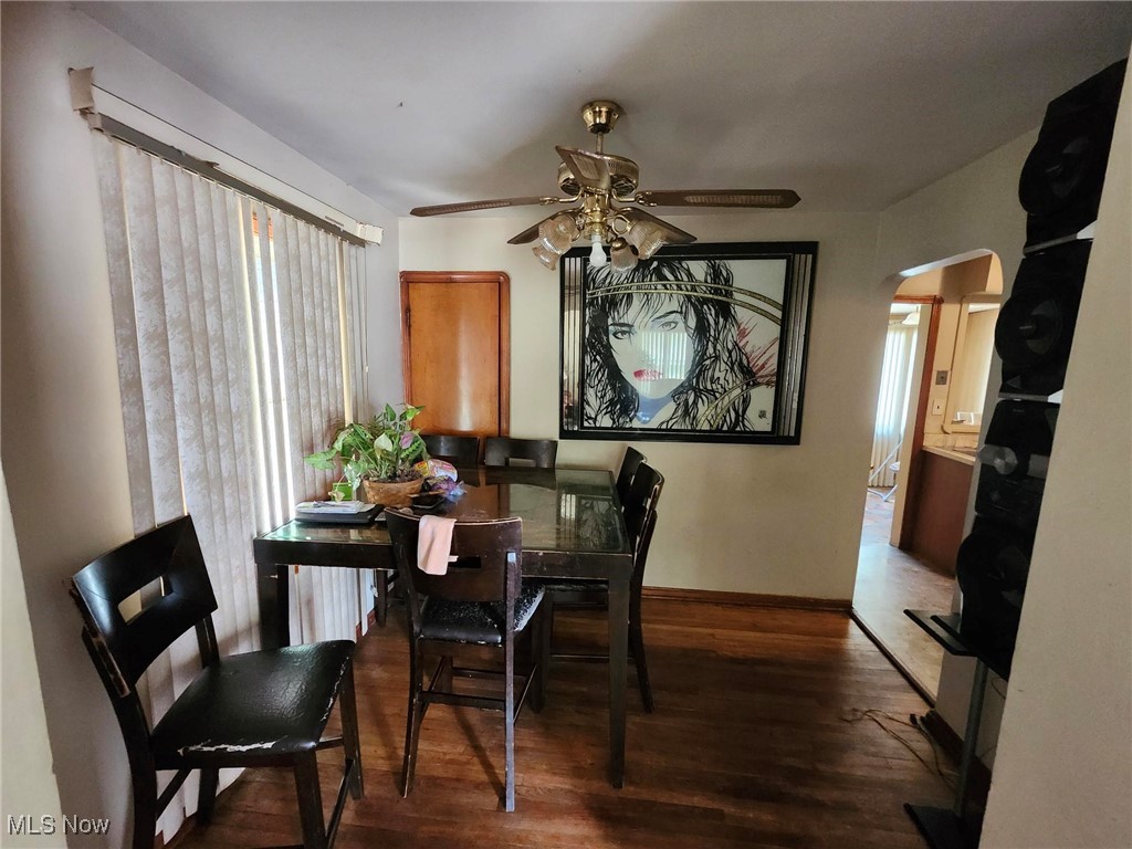 Dining space featuring ceiling fan and dark hardwood / wood-style flooring