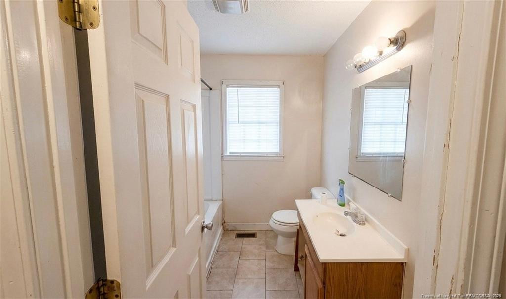 107 East Thigpen Road Conetoe, NC 27819 - Photo 8 of 13 a bathroom with a sink a toilet and mirror