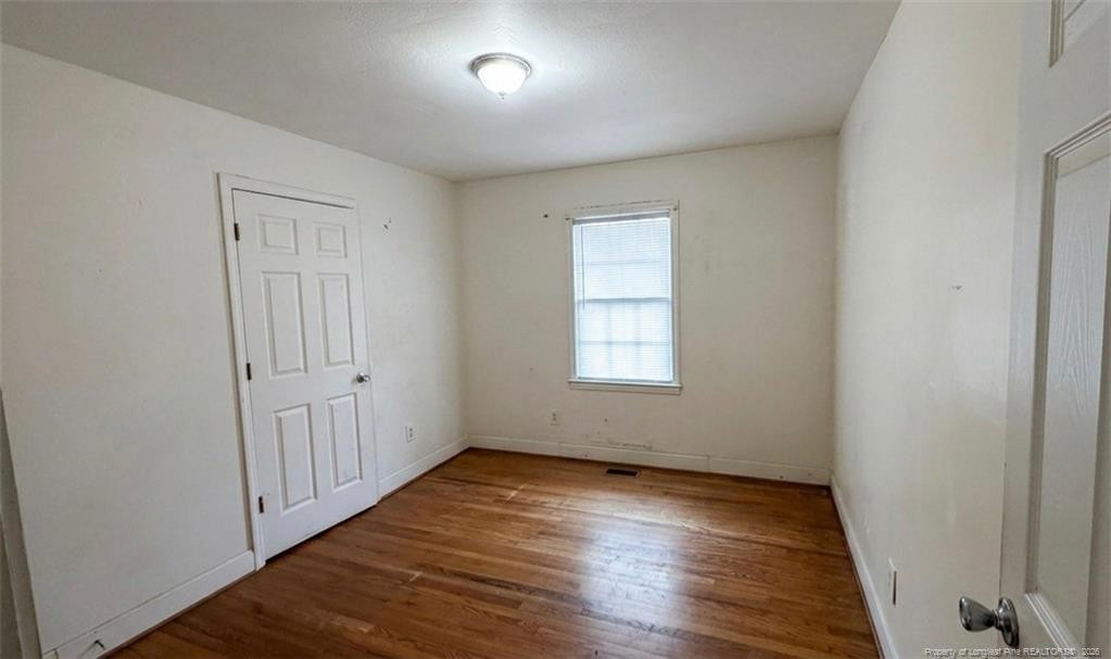 107 East Thigpen Road Conetoe, NC 27819 - Photo 9 of 13 an empty room with wooden floor and windows