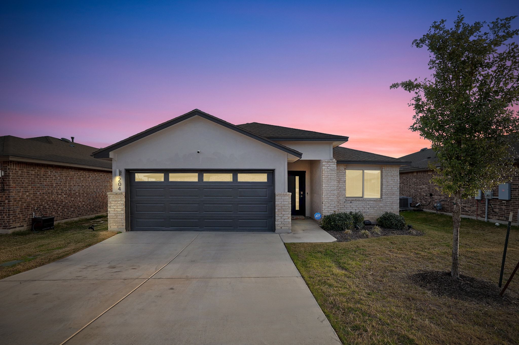 204 Halford Road Georgetown, TX 78633 - Photo 1 of 27 Ranch-style house with a front yard, stucco siding, a garage, concrete driveway, and brick siding