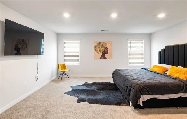 a bedroom with a bed and a couch