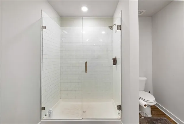 a bathroom with a shower and a toilet