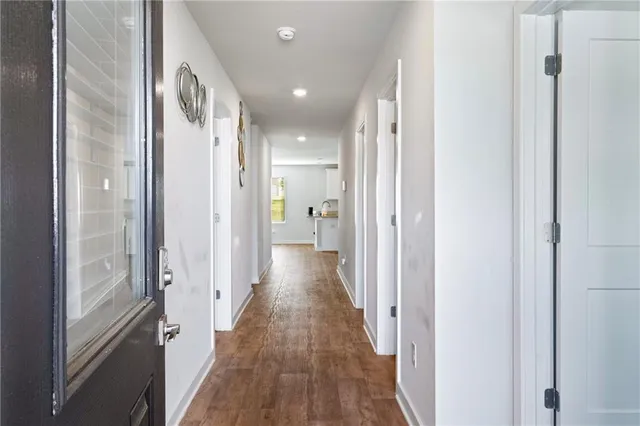 a view of hallway with wooden floor