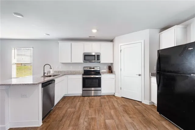 a kitchen with a refrigerator and a sink
