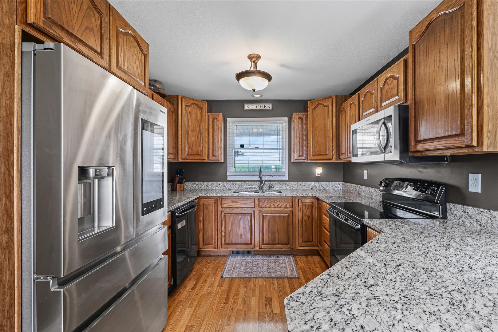 202 Hawk's Lane Broadlands, IL 61816 - Photo 11 of 31 a kitchen with stainless steel appliances granite countertop a refrigerator a stove and a sink