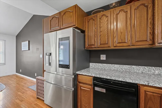 a kitchen with granite countertop wooden cabinets and a granite counter tops