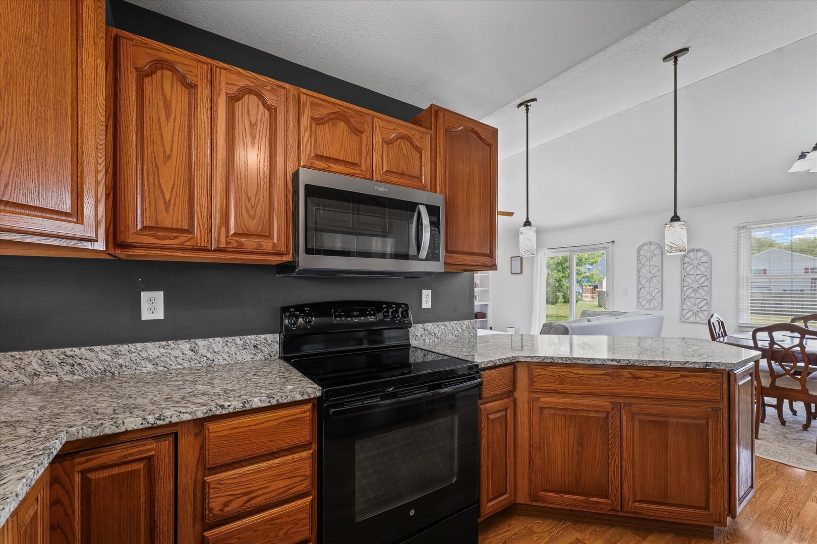 202 Hawk's Lane Broadlands, IL 61816 - Photo 14 of 31 a kitchen with granite countertop wooden cabinets and a stove top oven