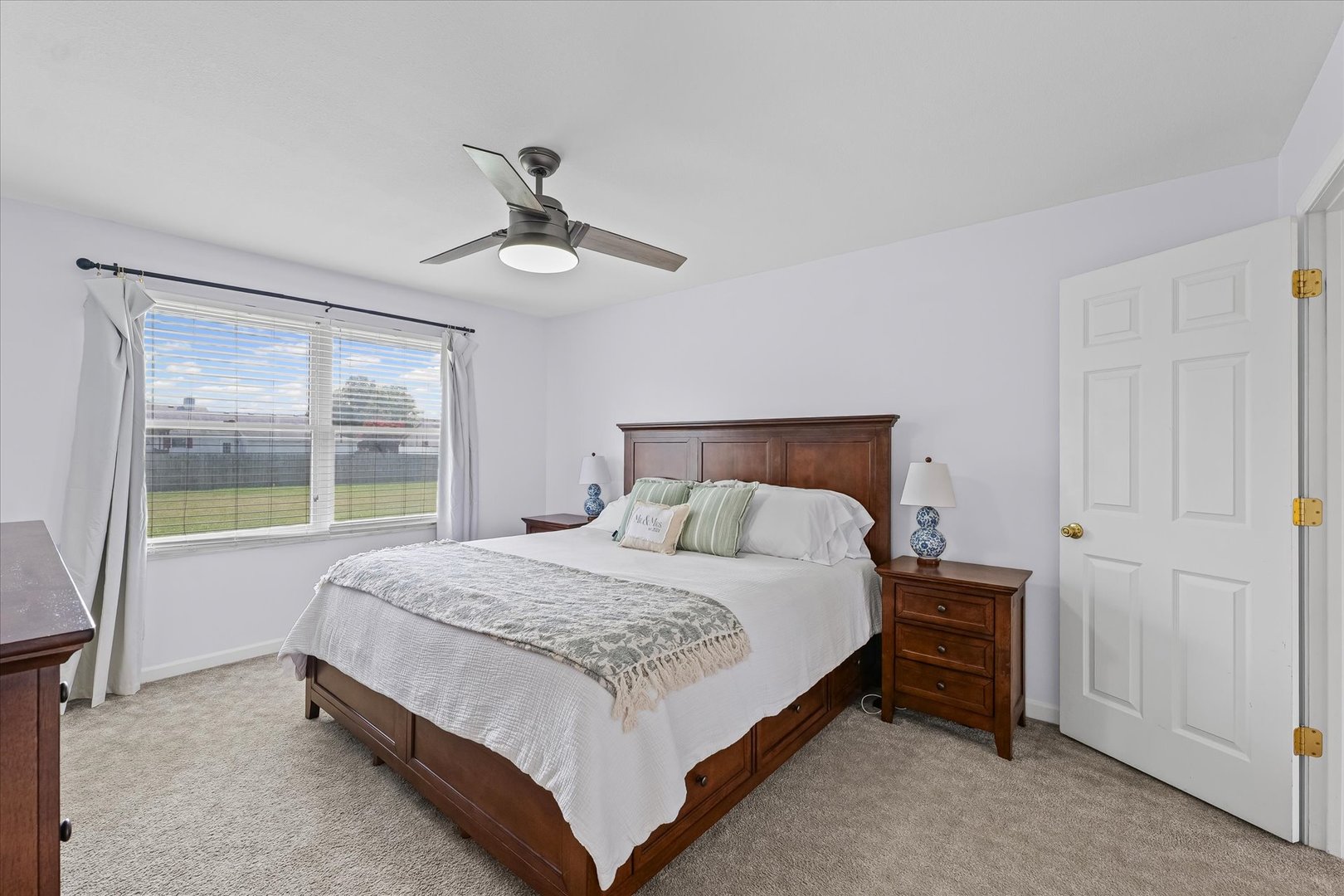 202 Hawk's Lane Broadlands, IL 61816 - Photo 17 of 31 a bedroom with a large bed and a chandelier