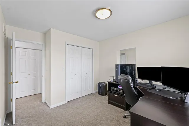 a view of a workspace with furniture and a gate