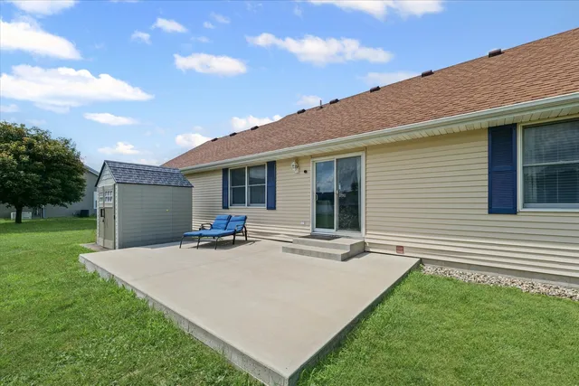 a backyard of a house with table and chairs