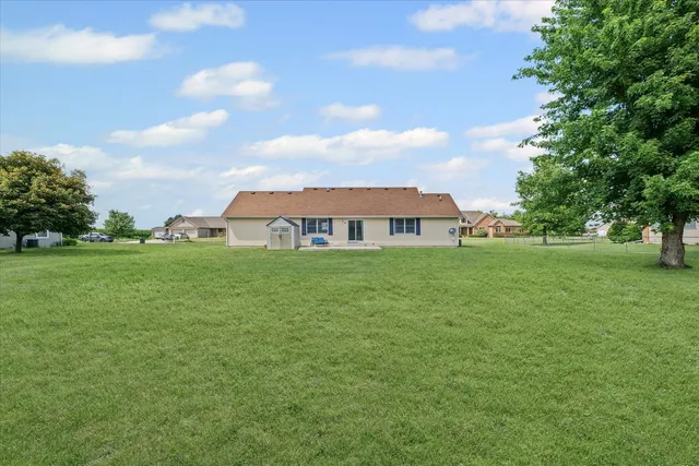 a view of an house with backyard space and balcony