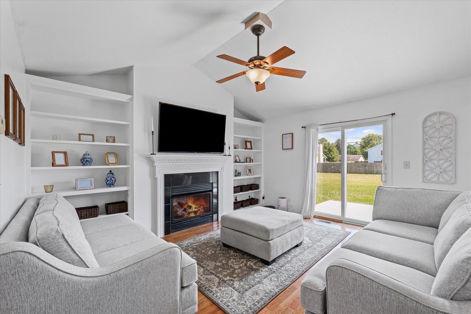 202 Hawk's Lane Broadlands, IL 61816 - Photo 5 of 31 a living room with furniture a fireplace and a flat screen tv