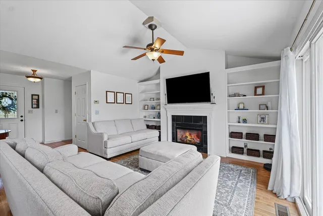a living room with furniture a fireplace and a flat screen tv