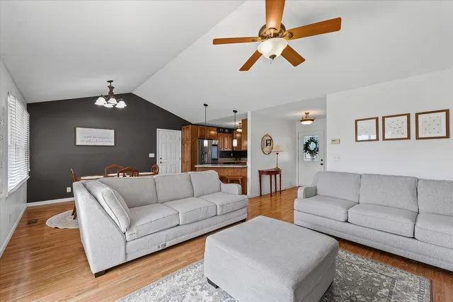 a living room with furniture and a ceiling fan