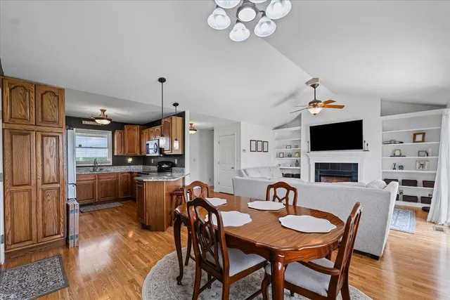a view of a dining room with furniture a rug and wooden floor