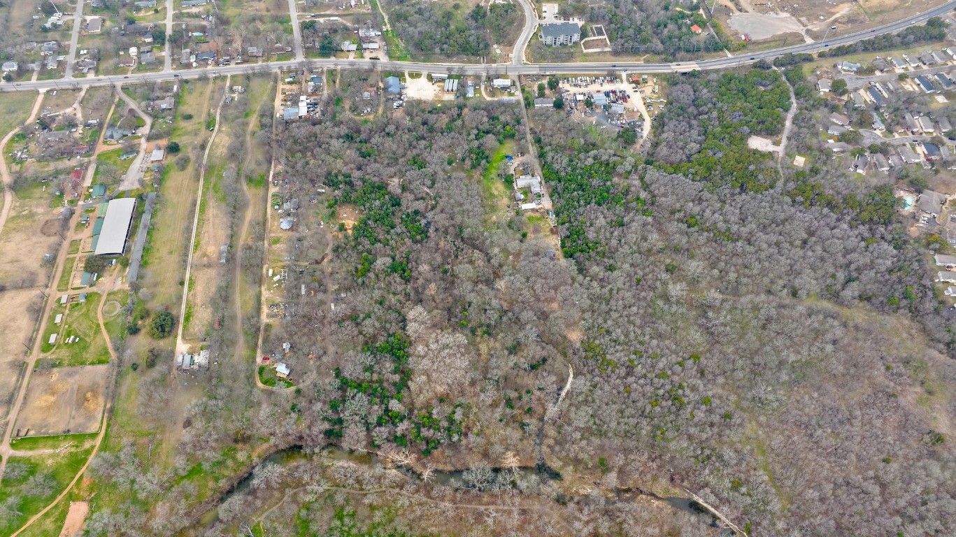 8303 Bluff Springs Road Austin, TX 78744 - Photo 14 of 16 a view of a yard with large trees