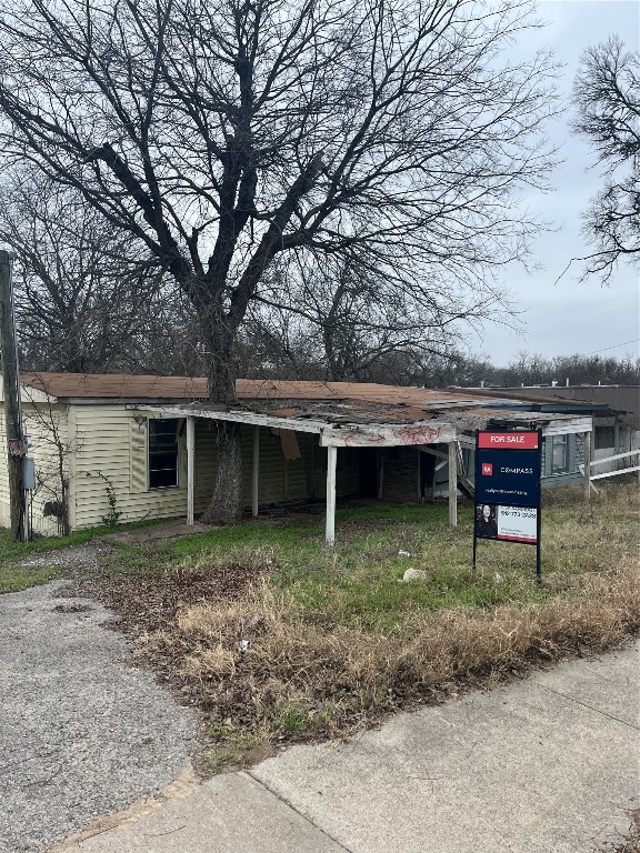 8303 Bluff Springs Road Austin, TX 78744 - Photo 3 of 16 a backyard of a house with barbeque oven table and chairs