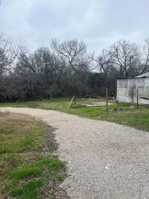 8303 Bluff Springs Road Austin, TX 78744 - Photo 5 of 16 a backyard of a house with lots of green space