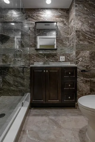 a bathroom with a sink a mirror and shower