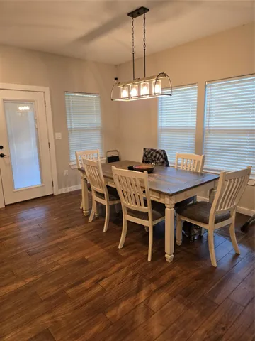 a view of a dining room with furniture wooden floor and chandelier