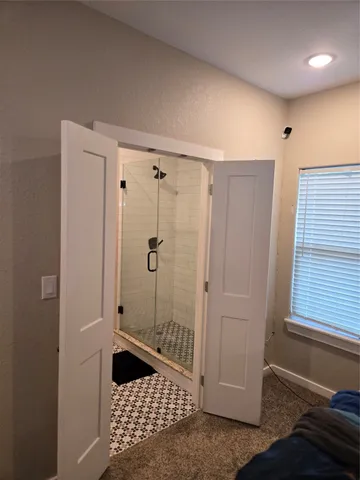 a bathroom with a shower and a window