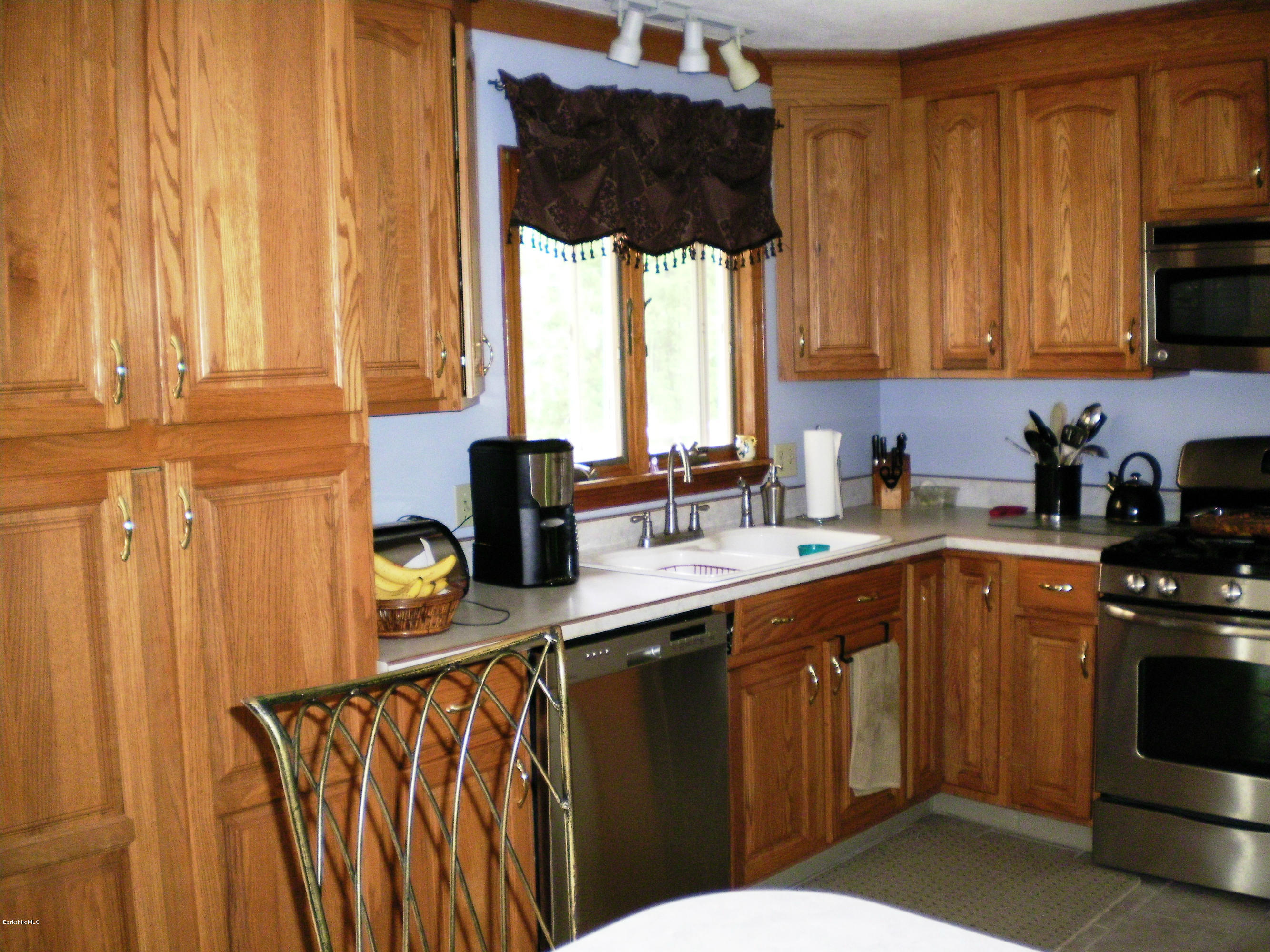 12 Andes Road Peru, MA 01235 - Photo 14 of 32 a kitchen with stainless steel appliances wooden cabinets a sink and a stove
