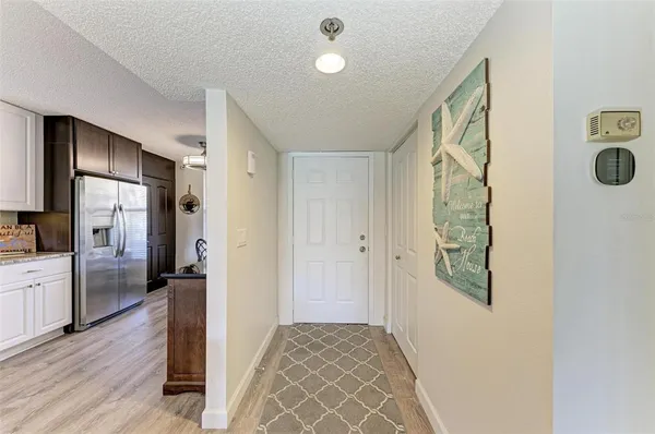 a view of a hallway view with wooden floor and staircase
