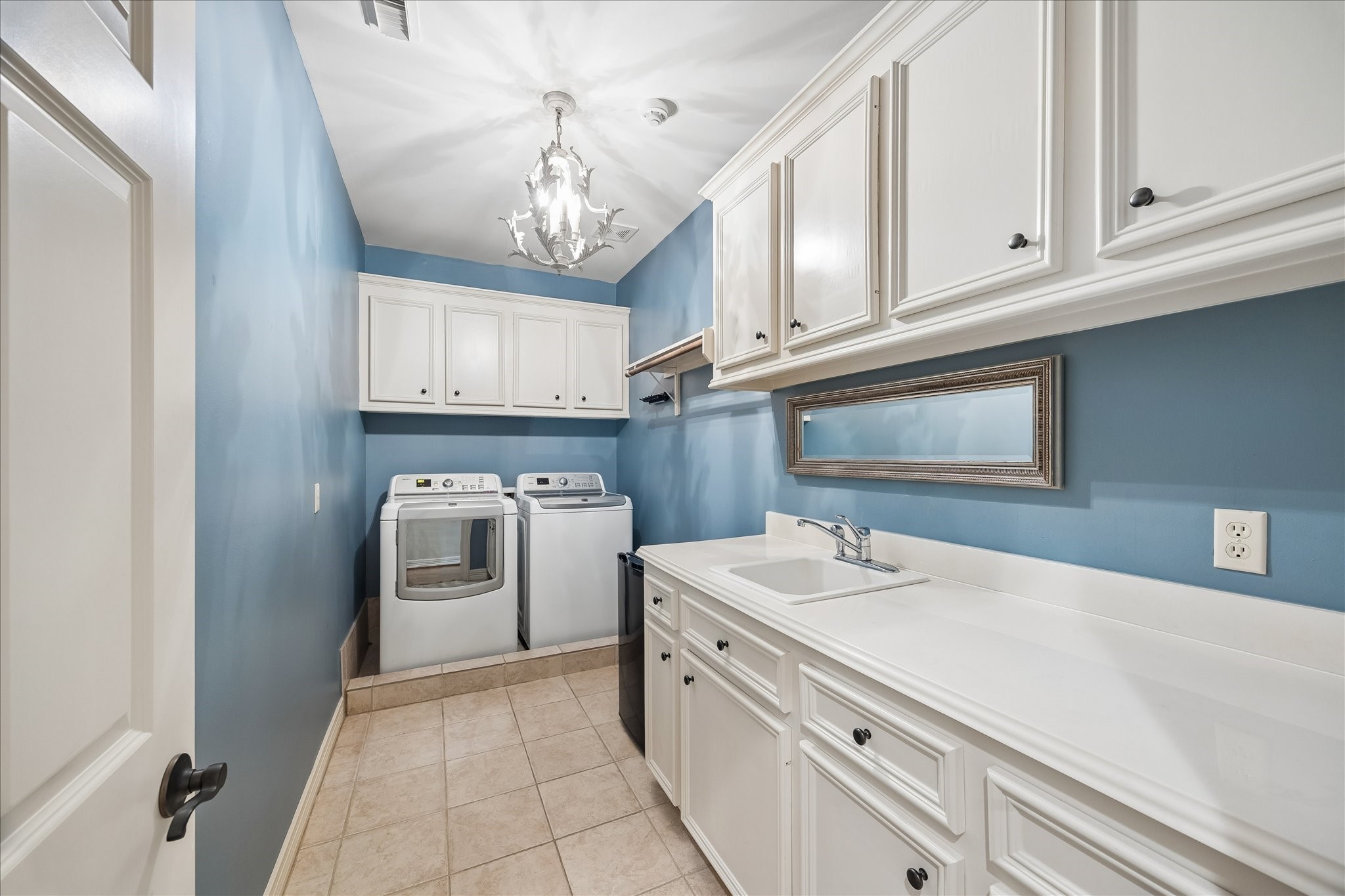 802 Anderson Street Bellaire, TX 77401 - Photo 25 of 36 The laundry room is wonderfully outfitted with cabinetry, hanging rod, lots of room to walk through, and a sink.
