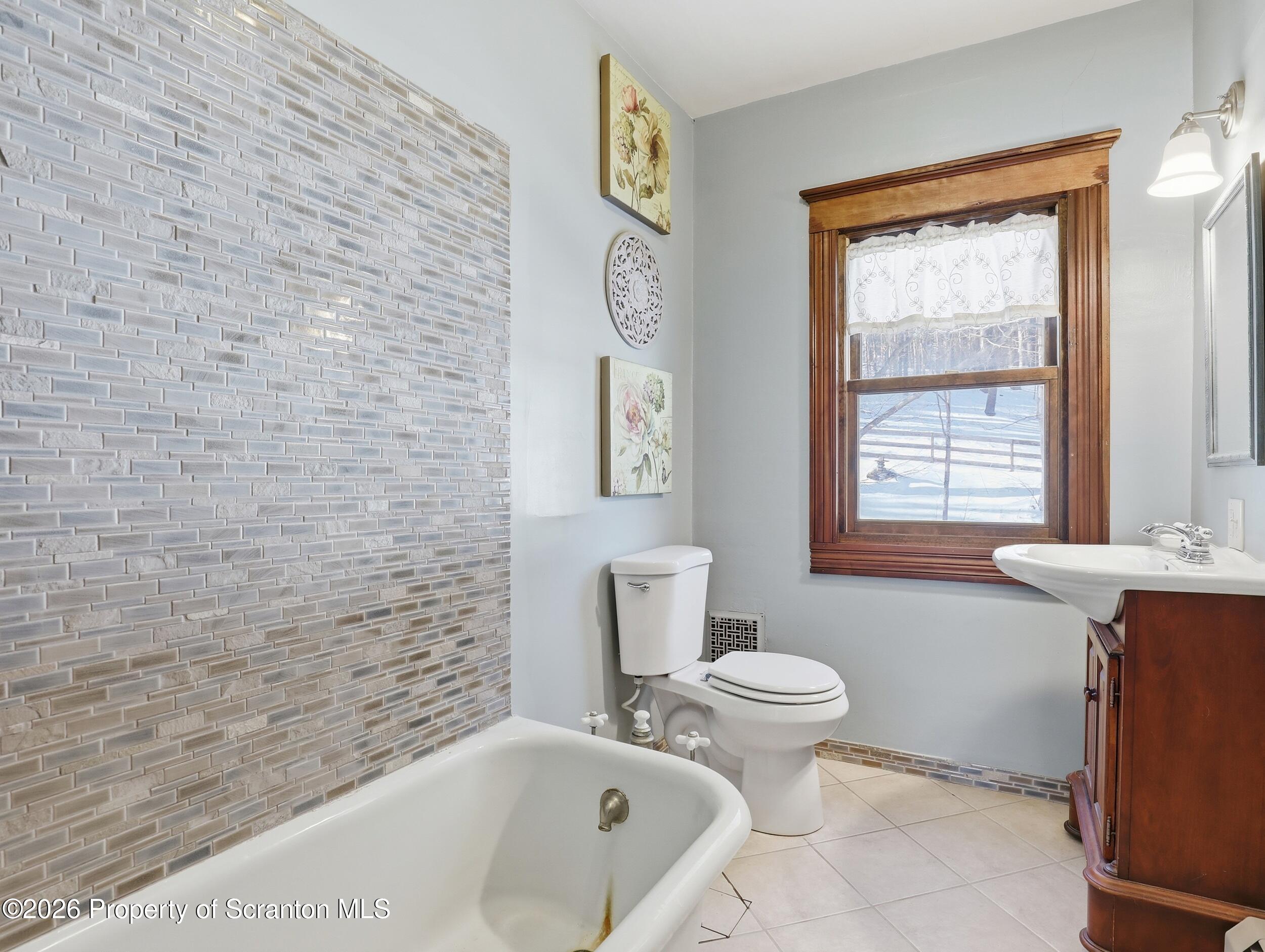 115 State Street Nicholson, PA 18446 - Photo 21 of 29 a bathroom with a toilet sink and mirror