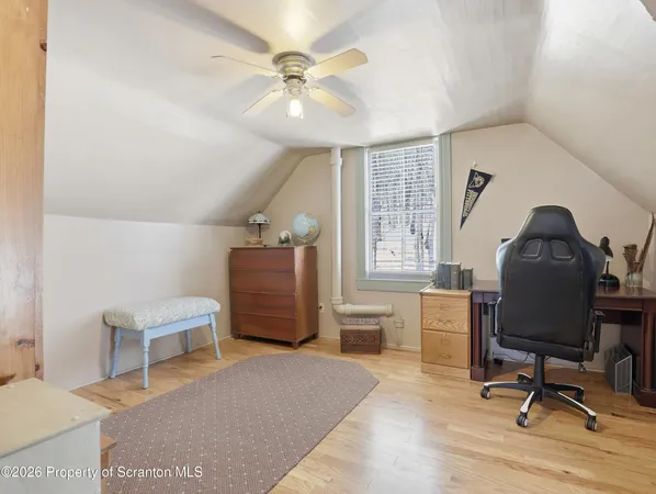a workspace with furniture hardwood and a window