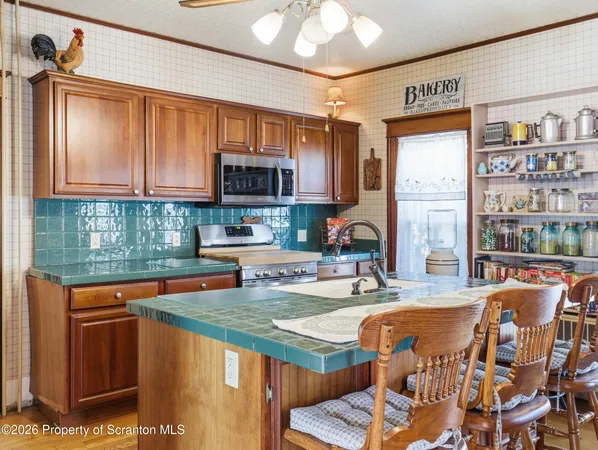 a kitchen with stainless steel appliances granite countertop a sink a stove and a refrigerator