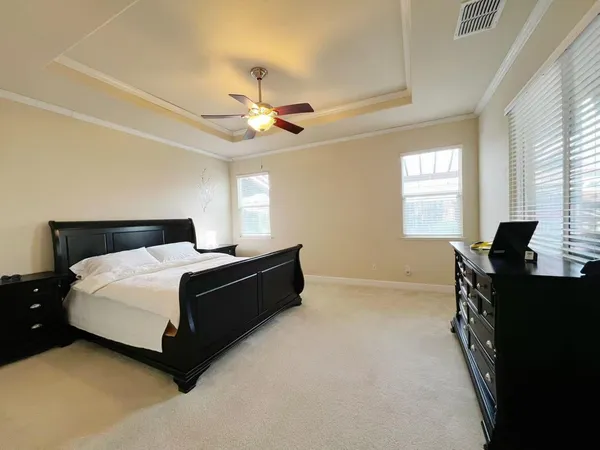 a bedroom with a bed and a chandelier