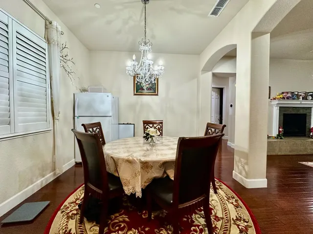 a view of a dining room with furniture wooden floor and chandelier