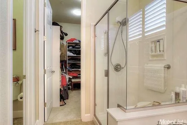 a bathroom with a shower and a sink