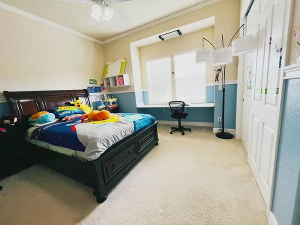 a bedroom with a bed dresser and a window