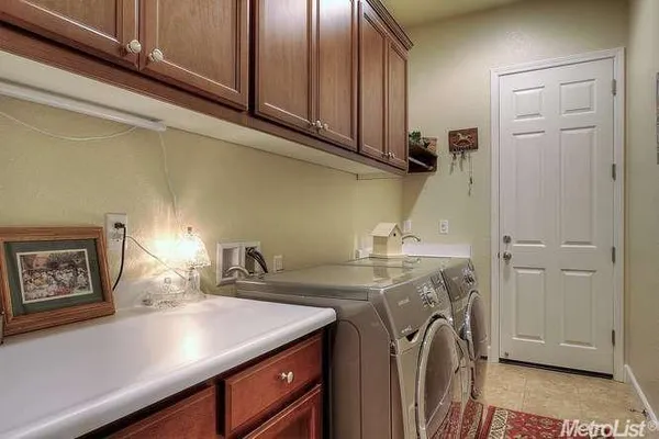a view of a kitchen with sink washer and dryer