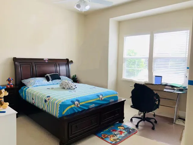 a bedroom with a bed and a chandelier